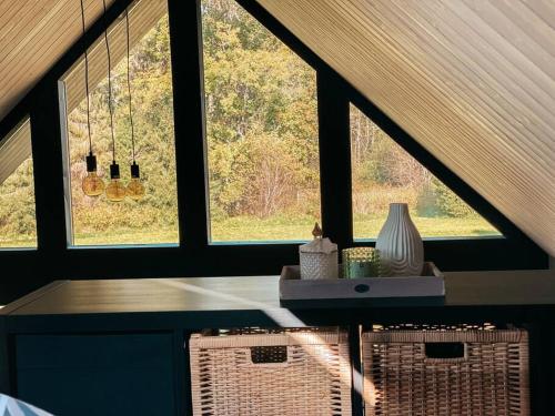 a room with two windows and a table and two chairs at Private Stay Zen House to unplug and recharge in Tuimõisa