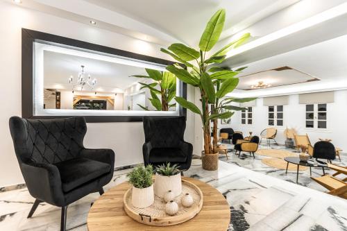 a living room with two chairs and a table at Anatoli Hotel in Naxos Chora