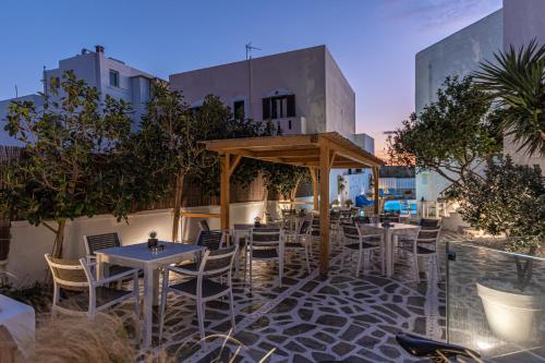 a restaurant with tables and chairs on a patio at Anatoli Hotel in Naxos Chora