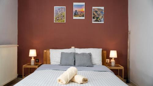 1 dormitorio con 1 cama con 3 cuadros en la pared en Country Side Cozy Villa en Kalabaka