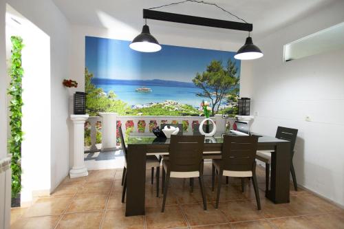 a dining room with a table with a view of the ocean at 3 bedrooms villa with private pool enclosed garden and wifi at Linares in Jaén