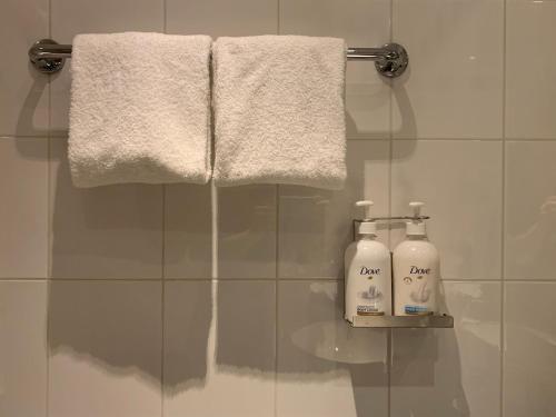 a bathroom with two bottles of soap and a towel at Holiday Inn - Salzburg City by IHG in Salzburg