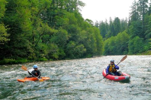 two people in kayaks on a river at Creekside Bed and Breakfast Guest Room in Deerhorn