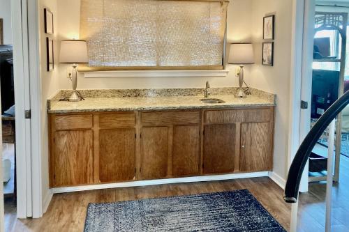 a bathroom with a sink and a mirror at Port O'Call C-303 in Isle of Palms