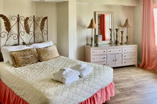 a bedroom with a large bed with towels on it at Port O'Call C-303 in Isle of Palms