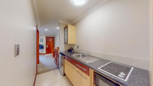 a kitchen with a sink and a counter top at Quantum Lodge Motor Inn in Hamilton