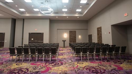 a large room with chairs and a podium in it at Candlewood Suites - Joliet Southwest by IHG in Joliet