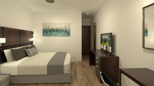 - une chambre avec un lit et une commode dans l'établissement Country Place Hotel, à Los Mochis