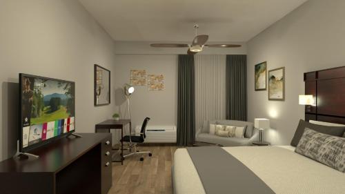 - une chambre avec un lit et un bureau avec une télévision dans l'établissement Country Place Hotel, à Los Mochis