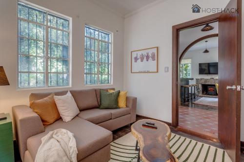 a living room with a couch and a mirror at Refurbished Mansion with Garden & Patio in Las Lomas - Monte Blanco in Mexico City