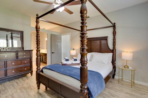 a bedroom with a four poster bed and a ceiling fan at Renovated Sunny Port St Lucie Home with Outdoor Pool in Port Saint Lucie