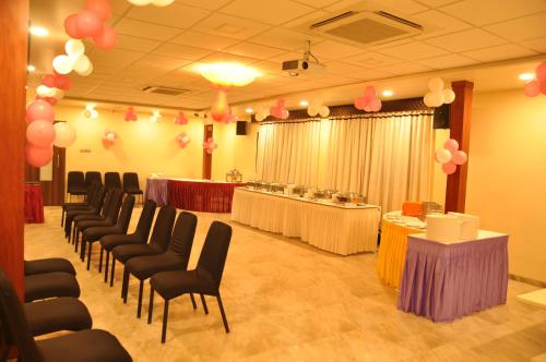 a conference room with chairs and tables and balloons at Hotel Green Olive in Aurangabad
