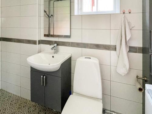 a bathroom with a toilet and a sink at Holiday home KARLSKRONA IV in Karlskrona