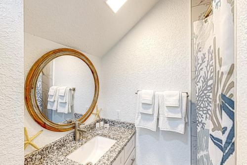 a bathroom with a mirror and a sink at Tarpon Breeze in Marathon