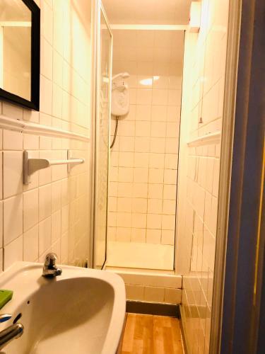 a small bathroom with a sink and a shower at AC Hideout in Rochford