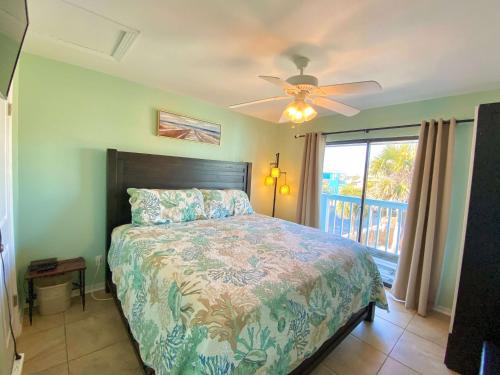 a bedroom with a bed and a ceiling fan at Lani Kai Village 211 by ALBVR - Beautifully Remodeled Condo with Indirect Gulf views from Balcony! in Gulf Shores