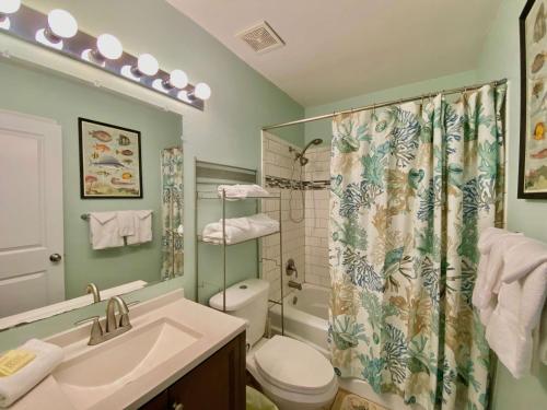 a bathroom with a shower and a toilet and a sink at Lani Kai Village 211 by ALBVR - Beautifully Remodeled Condo with Indirect Gulf views from Balcony! in Gulf Shores