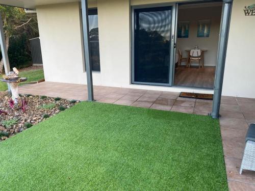 a yard with green grass in front of a house at Mapleton Springs in Mapleton