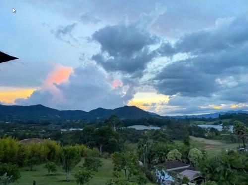 a view of a valley with mountains and clouds at Alto Paraíso Glamping Carmen de Viboral in Rionegro