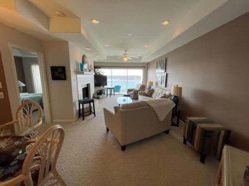 a living room with a couch and a table at Rare GEM @Emerald Bay - Smart Home - THAT VIEW!!! in Lake Ozark