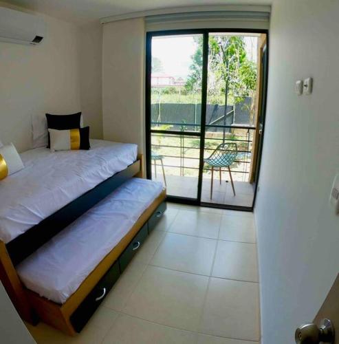 a bedroom with two beds and a balcony at Descanso y Confort 3 Luxury in La Tebaida