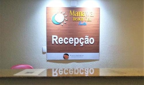 a sign on a wall in a room at Flat Manawa Beach - Porto de Galinhas in Porto De Galinhas