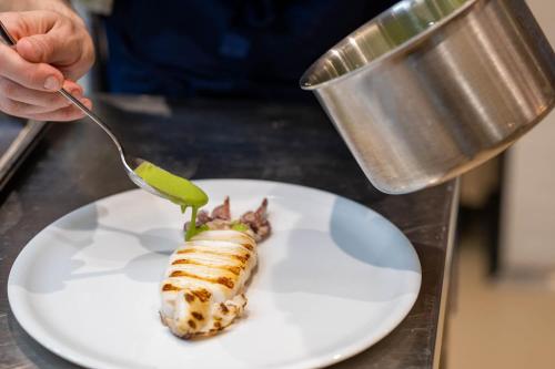 a person eating a piece of food on a plate at Palazzo Tafuri Boutique Hotel in Nardò