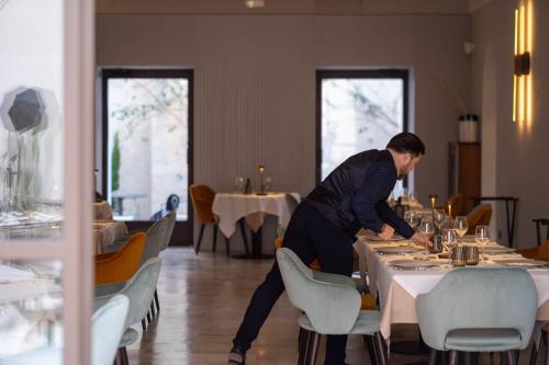 a man standing at a table in a restaurant at Palazzo Tafuri Boutique Hotel in Nardò