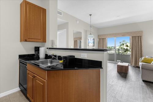 a kitchen with a sink and a counter top at The Point, Lux Apartment 4 min from Universal in Orlando