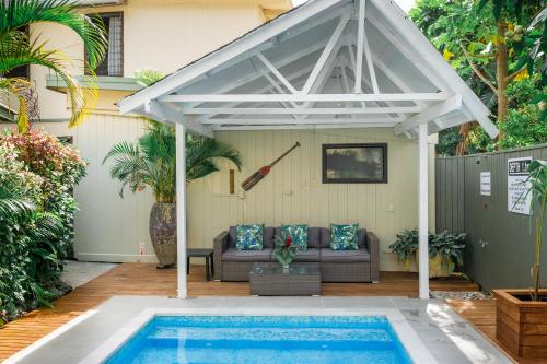 a pergola over a swimming pool in a backyard at The Cooks Oasis in Rarotonga