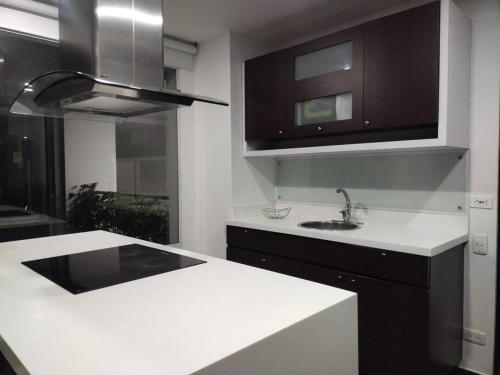 a kitchen with a white counter and a sink at Espectacular Dúplex moderno in Bogotá