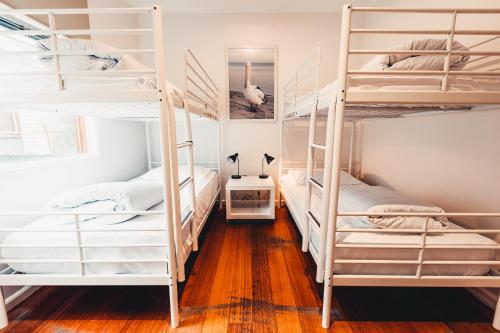 a room with four bunk beds in a room at Beach Holiday Apartments in Rye