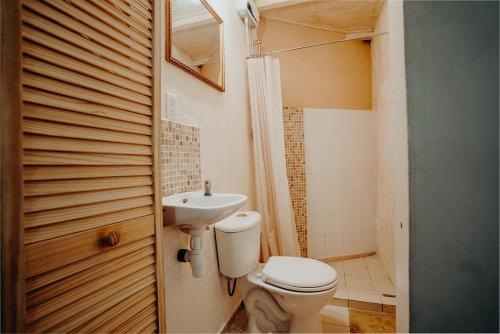 a bathroom with a toilet and a sink at Homey Vacation in Willemstad