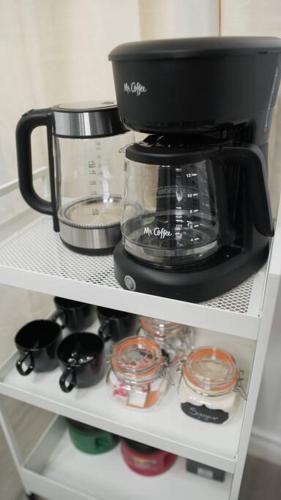 a coffee maker sitting on top of a shelf at Artful Retreat - King Bed, Work Desk, WIFI, Unique Murals, Perfect for Business Travelers, Downtown & Near Universal Studios in Burbank