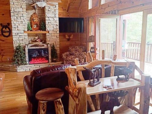 a living room with a table and a fireplace at The Moose Cove Hideaway on the Lake in Dandridge