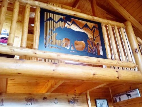 a wooden staircase in a log cabin with a ceiling at The Moose Cove Hideaway on the Lake in Dandridge