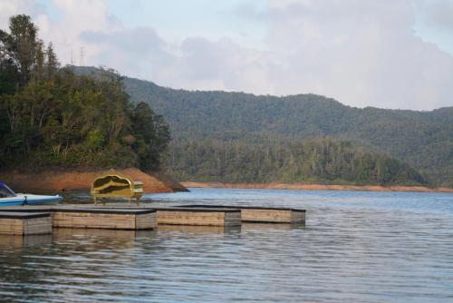 a dock in the middle of a body of water at Bethel Lozana Guatape in Guatapé