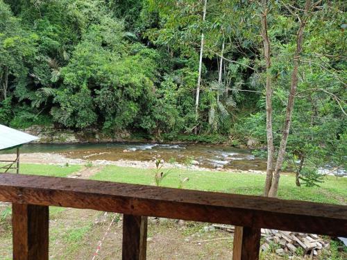 a view of a river from a wooden fence at Kuriou Lodge & Campsite in Kiulu