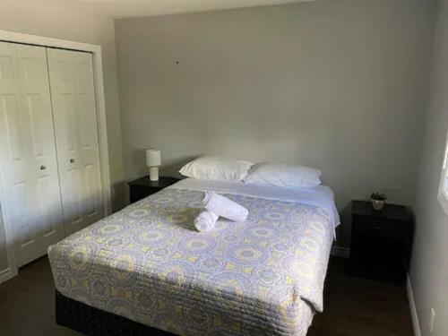 a bedroom with a bed with two towels on it at Kingston Comfort Suites - Unit 2 in Kingston