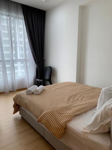a bedroom with a bed with two towels on it at Barakah Homestay @ Meru Casa Kayangan in Ipoh