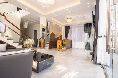 a living room with a staircase and a lobby at Happy Home Da Lat in Da Thanh