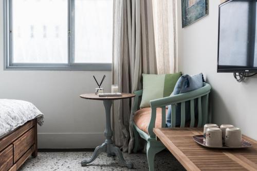 a bedroom with a bed and a table and a chair at Seamoon House in Tainan