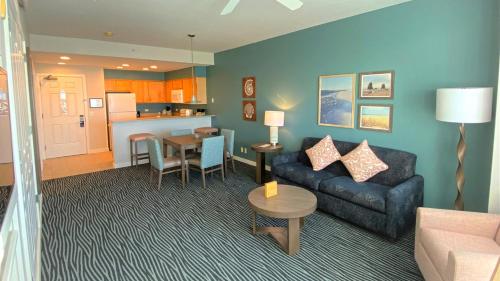 a living room with a couch and a table at WorldMark Seaside by BookTimeShares in Seaside