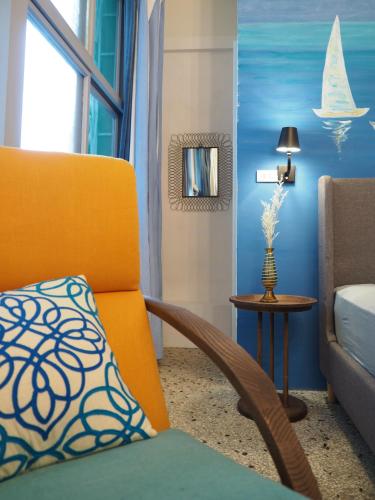 a living room with a couch and a chair at Seamoon House in Tainan