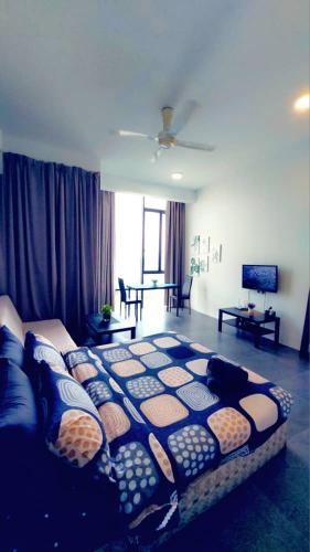 a large bed in a living room with a couch at Maya empire studio in Kampong Bukit Lanjan