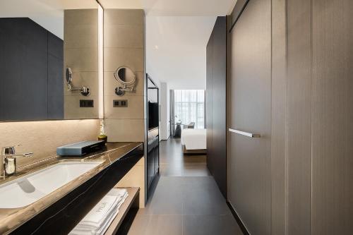 a bathroom with a sink and a mirror at Hua Hotel -Nanshan Technology Park in Shenzhen