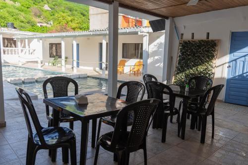 a table and chairs on a patio with a pool at Casa Toboro in Taganga
