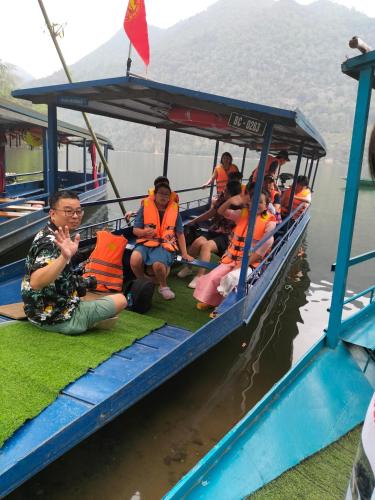 a group of people riding on a boat in the water at Nam Pé Tày Homestay - View hồ Ba Bể in Bak Kan