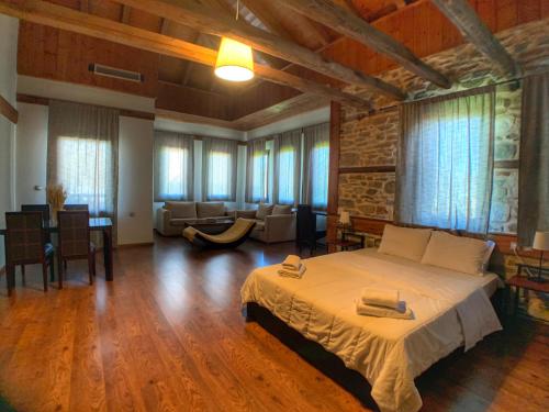 a bedroom with a large bed and a living room at Hotel Apsis in Emporio