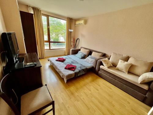 a living room with a couch and a table at Julia Vigo Panorama apartments in Nesebar